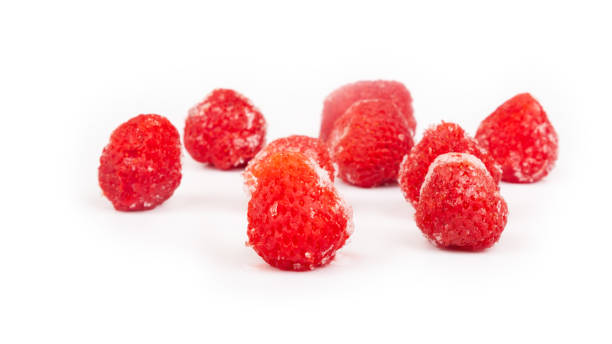 istock frozen strawberries isolated on white background, ice berry 1368292677