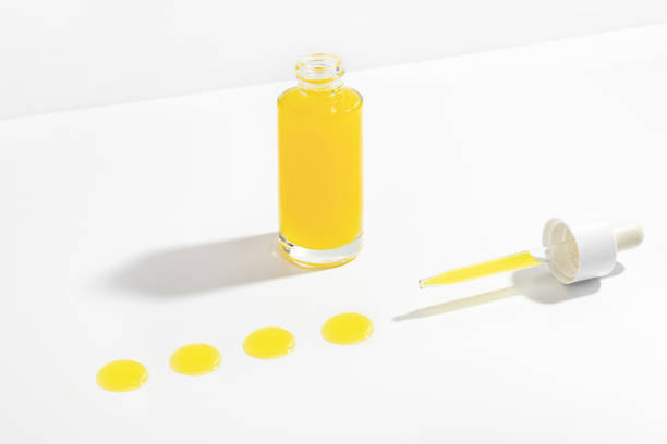istock Vitamin C serum in cosmetic bottle and dropper. 1368293349