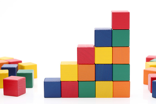 toys blocks step stair, building bricks on a white background