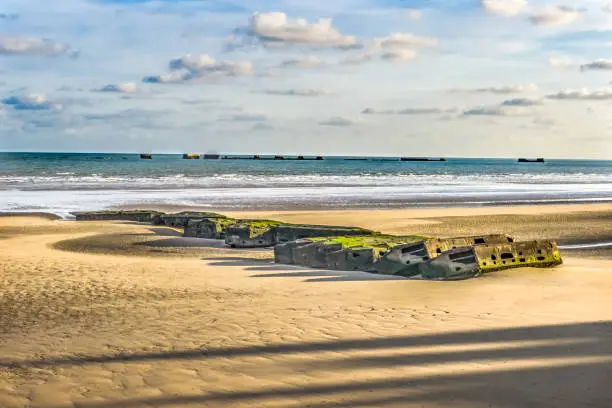 Old Ramp Beach World War 2 Mulberry Harbor Artificial Port Arromanches-les-Bains Normandy France. Through Beach and Ramp 104,000 tons military  supplies in six days
