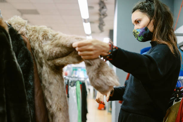 istock woman browsing through the second hand clothing in Berlin 1368302685