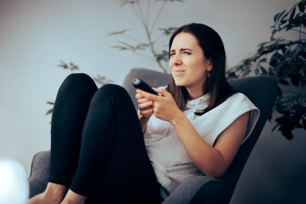 Woman Squinting while Watching TV Needing Her Eyeglasses to See