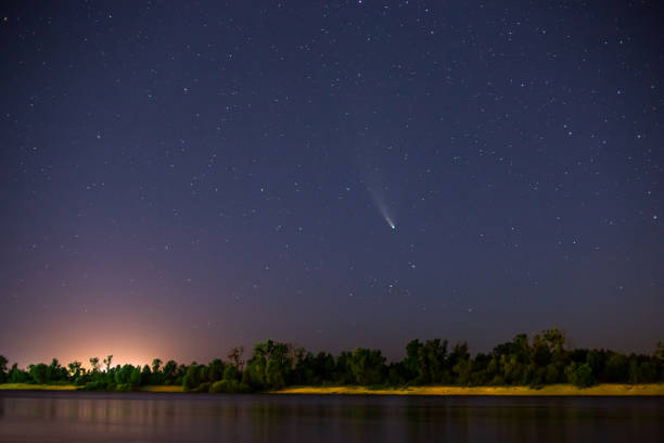 istock Comet in the night sky. Summer starry sky. Stars on the sky. Beautiful night landscape. Long exposure. Conceptual photography. Fog over the water. Atmospheric landscape. 1368304443