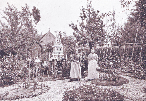Two Dutch women tend a garden in Broek, Netherlands (Holland). Photo by Dr. Charles Mitchell commissioned for an 1894 book about Holland. Source: Original edition is from my own archives. Copyright has expired and is in Public Domain.