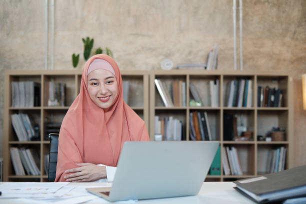 Beautiful Islamic female small business founder portrait in office. stock photo