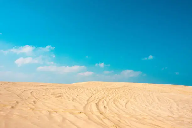 Golden dunes beach in madero city tamaulipas, sand mountain with vehicle marks and blue sky, no people