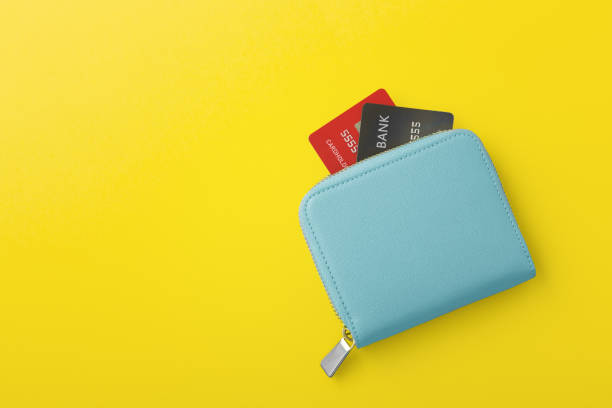 istock Blue wallet with credit card on yellow background 1368318715