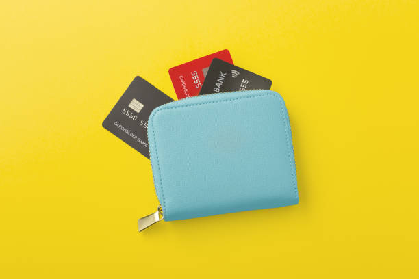 istock Wallet with credit card on yellow background 1368318724