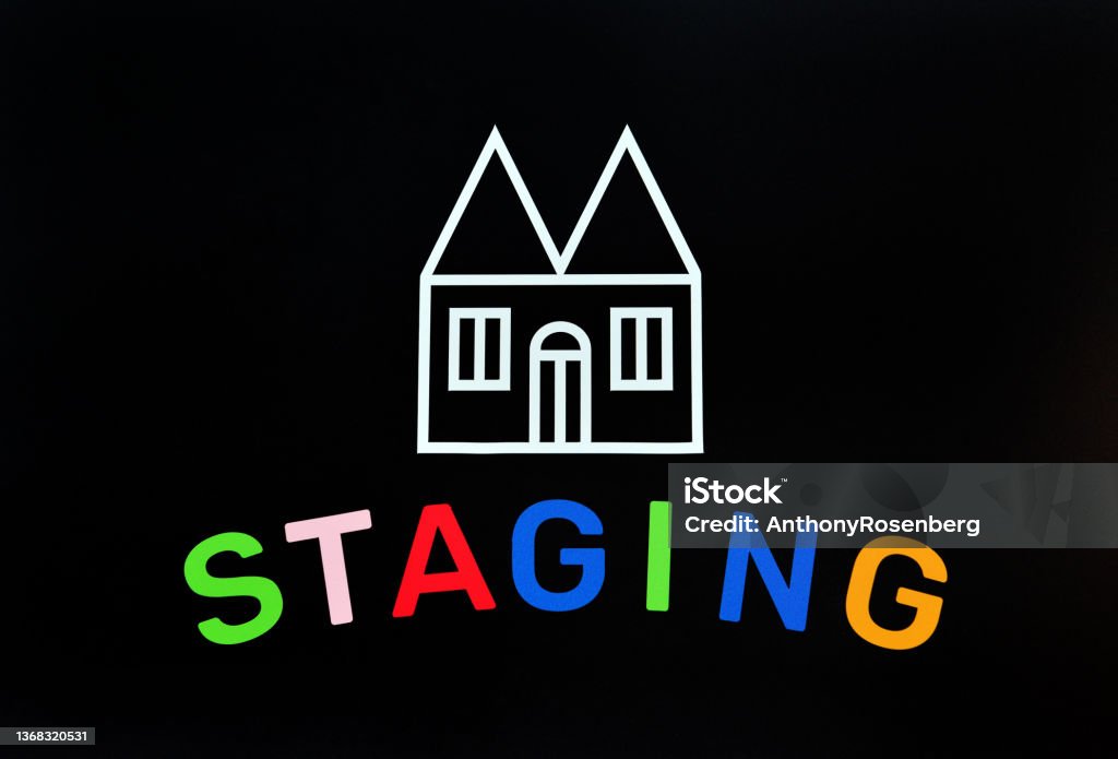Home Staging Closeup of a home shape with the word staging symbolizing a home staging real estate concept. Home Interior Stock Photo