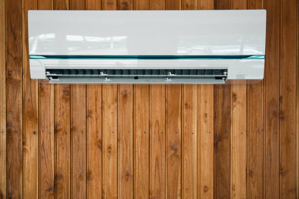 Air conditioner installed on the wooden wall. stock photo