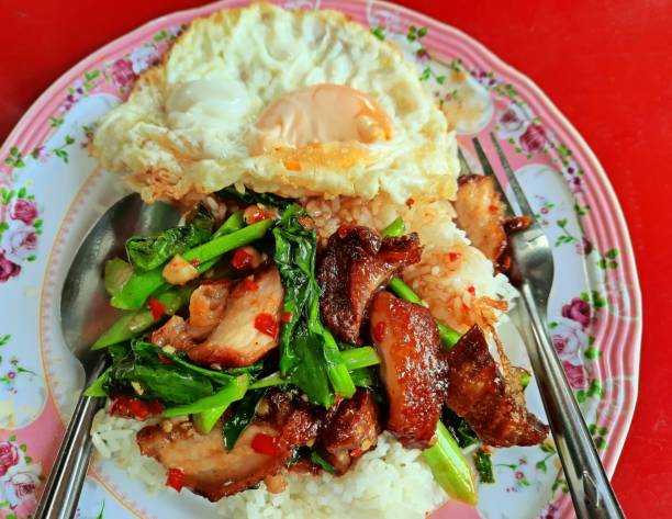istock Stir fried Kale vegetable with Crispy pork belly and fried egg on rice - Thai food. 1368321691