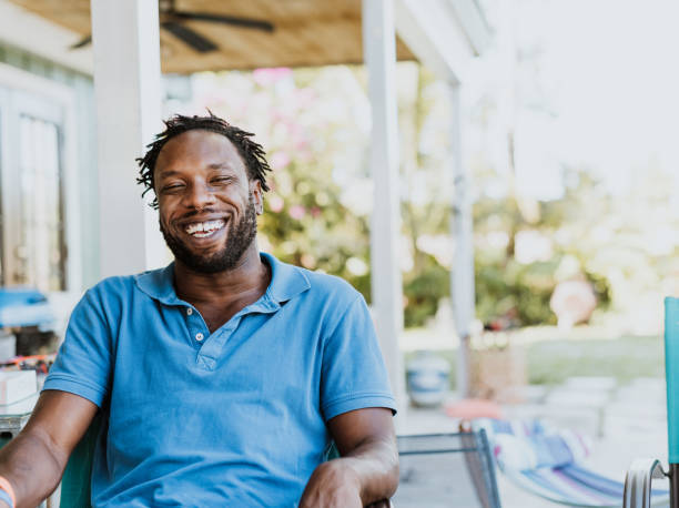 Cool mid-adult Black man in joyous moment laughing outdoors