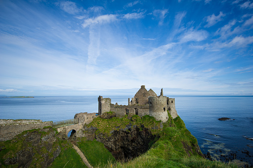 Ruins of medieval Dunluce castle in County Antrim, Northern Ireland. The fort was built along the coastline cliffs.