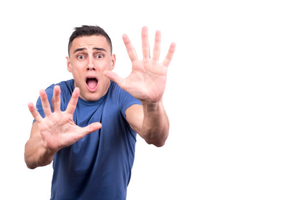 istock Frightened man with both palms raised in a stop sign 1368329529