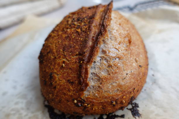 istock artisan bread, wholegrain with spice,  fresh on baking paper 1368329746