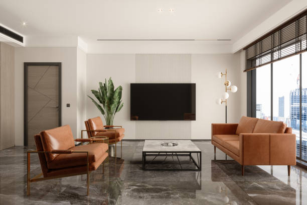 salle d’attente moderne avec canapé en cuir, fauteuils, table basse, télévision et paysage urbain depuis la fenêtre - tv wall unit photos et images de collection