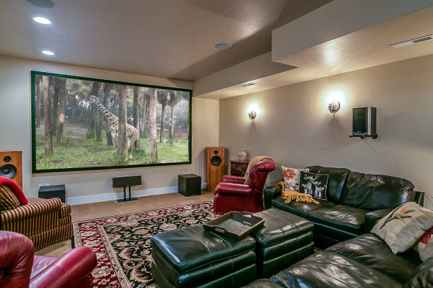 Amazing and comfortable theater room in new home Surround sound system and huge screen allow for epic movie nights surround sound stock pictures, royalty-free photos & images