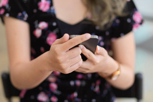 istock Close-up image of a female using her mobile phone. 1368334030