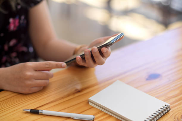 istock Close-up image, focus hands, A female using a smartphone 1368334088