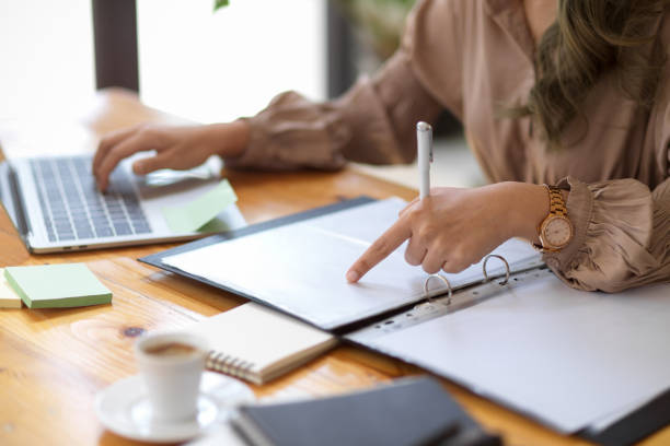 istock Cropped image, A female employee pointing finger on documents. 1368334739