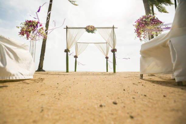 istock wedding arch decorated on tropical sand beach, outdoor beach wedding setup. 1368337860