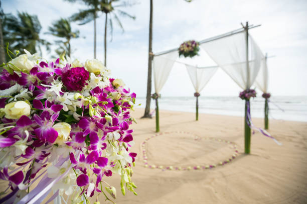 istock wedding arch decorated on tropical sand beach, outdoor beach wedding setup. 1368338442