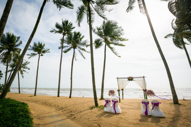 istock wedding arch decorated on tropical sand beach, outdoor beach wedding setup. 1368338470