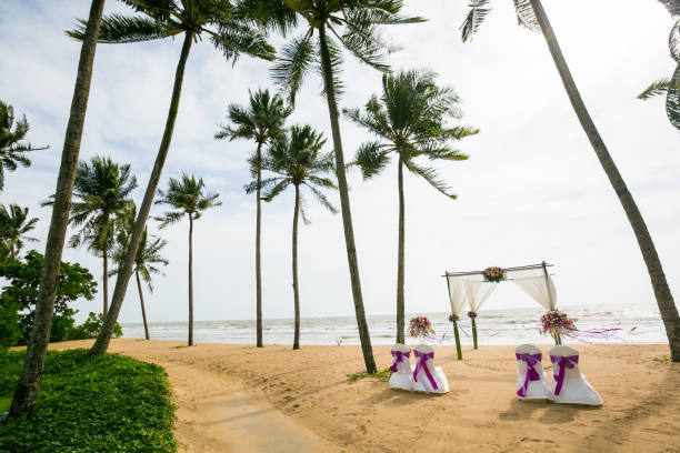 istock wedding arch decorated on tropical sand beach, outdoor beach wedding setup. 1368338472