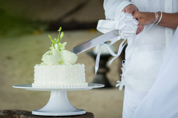 istock Wedding cutting a wedding cake on wedding day. 1368339038