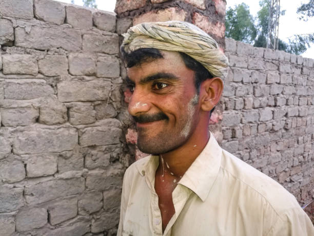 istock an asian poor labor is working on the site and smiling and his has crossed eyes 1368346572