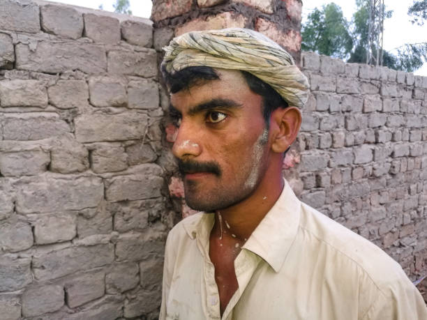istock an asian poor labor is working on the site and smiling and his has crossed eyes 1368346573