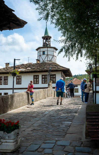 Tourists on the Garbaviat (Humpback) Bridge and Medieval clock Tower in the historical town of Tryavna Tryavna, Bulgaria - September 8, 2021: Tourists on the Garbaviat (Humpback) Bridge and Medieval clock Tower in the historical town of Tryavna. Bulgaria, Europe. bulgarian culture bulgaria bridge river stock pictures, royalty-free photos & images