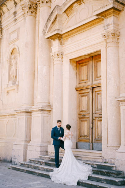 istock Couple Standing In Front Of Building 1368348385