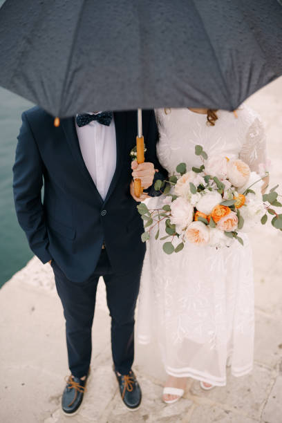 istock Midsection Of Man Holding Flower Bouquet 1368348507