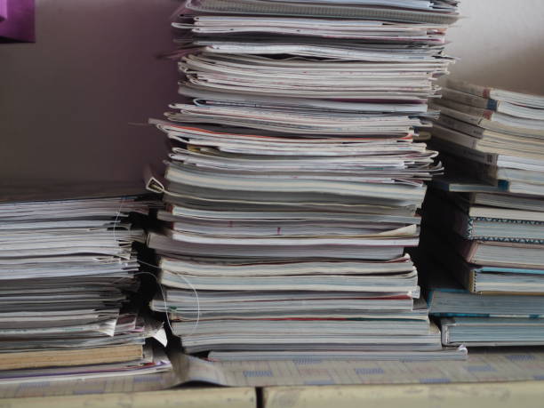 istock Books stacked on top of cabinets 1368349288