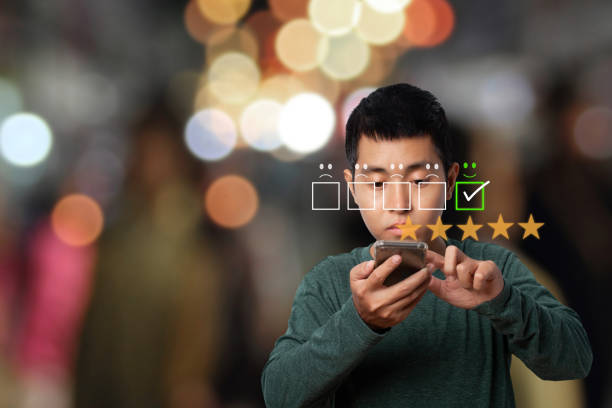 istock Asian man using smartphone with customer service evaluation in satisfaction. 1368350140