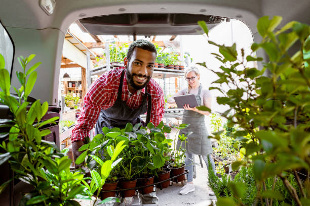 istock Garden center workers transporting plants in a van 1368350978