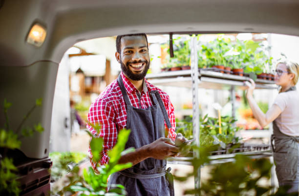 istock Garden center workers transporting plants in a van 1368351176