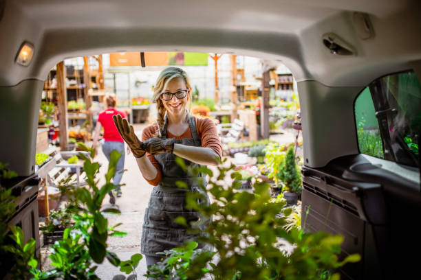 istock Garden center workers transporting plants in a van 1368351425