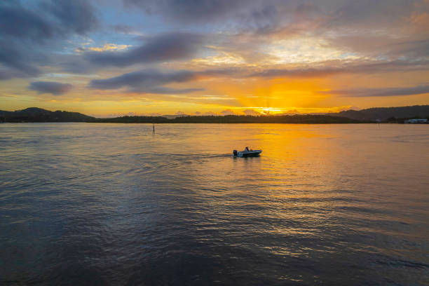 istock Sunrise waterscape with a mix of low, medium and high clouds 1368352589