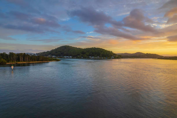 istock Sunrise waterscape with a mix of low, medium and high clouds 1368352664