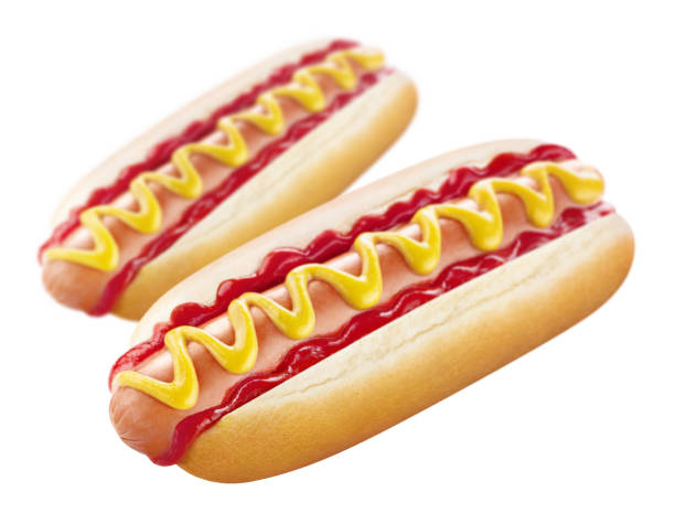 istock Two delicious hot dogs, low depth of field, on white 1368353785