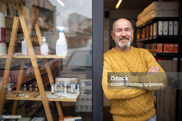 Proud Owner Standing With Arms Crossed In Front Of His Store Stock Photo - Download Image Now