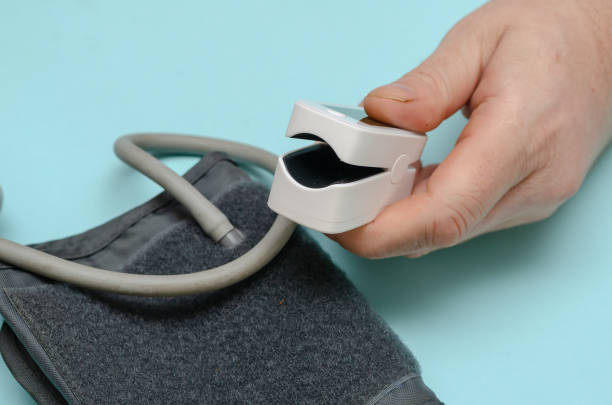 istock A hand holds an open white oximeter. 1368356253