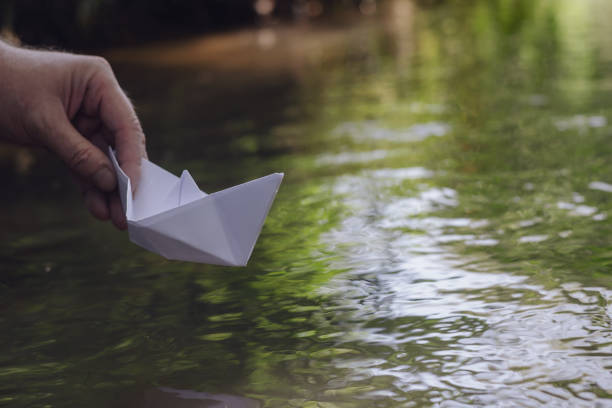 istock Man holds the homemade boat. 1368356272