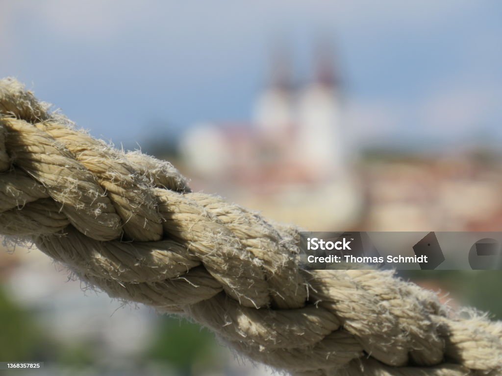 Rope in the foreground with blurred Church of Medulin in Croatia Close-up Stock Photo
