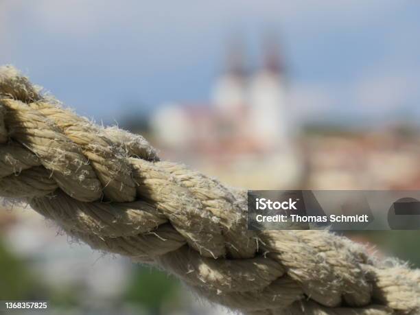 Rope In The Foreground With Blurred Church Of Medulin In Croatia Stock Photo - Download Image Now