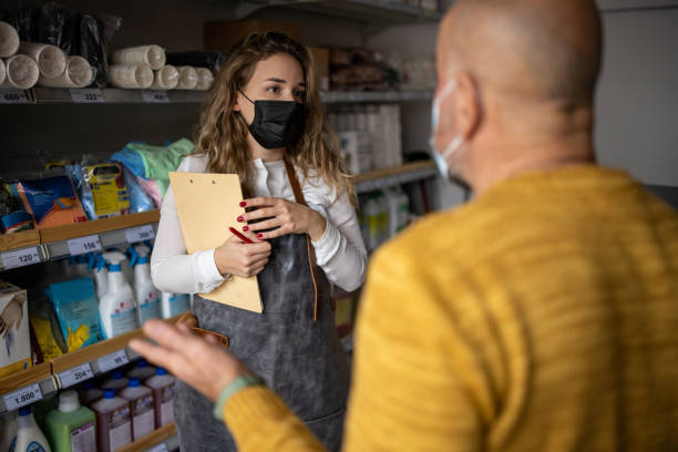 istock While wearing protective face mask, female employee having a discussion with dissatisfied customer 1368357861