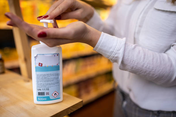 istock Unrecognizable woman using hand sanitizer 1368359216