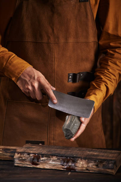 istock The butcher sharpens a knife on a whetstone. 1368360501